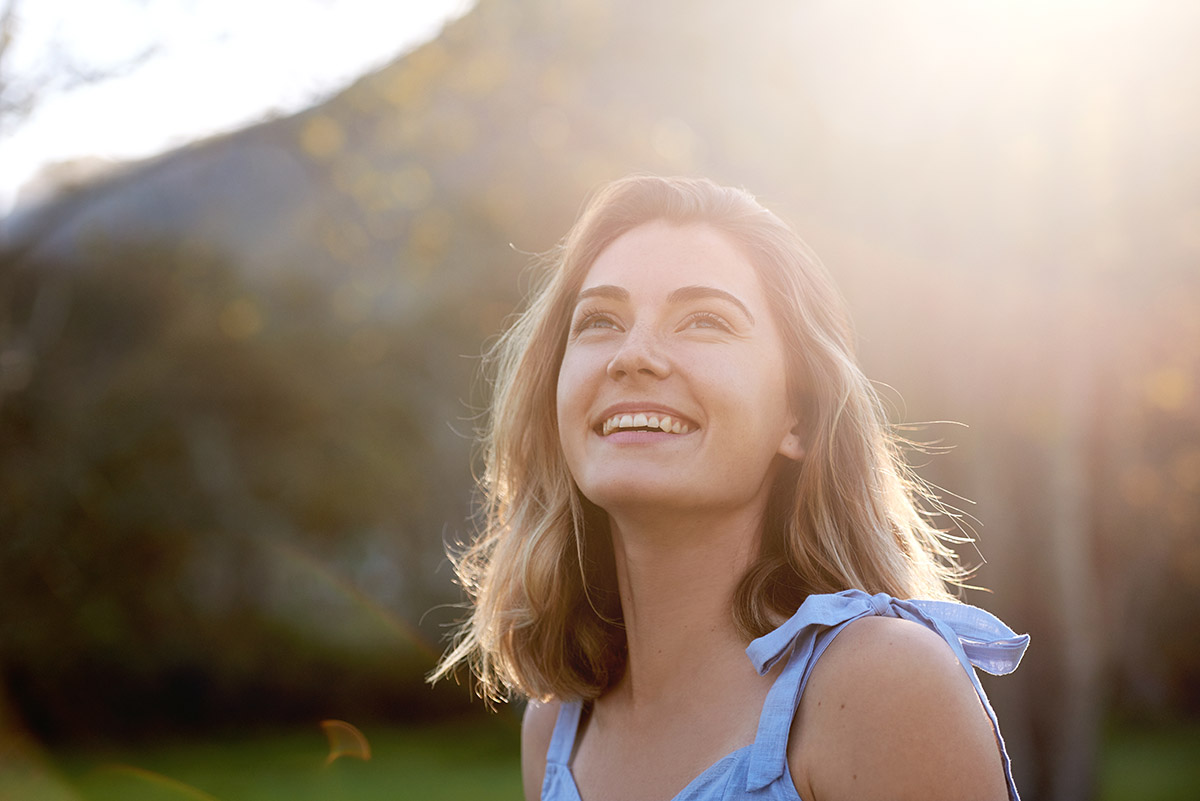 woman smiling outside and moving on from addiction