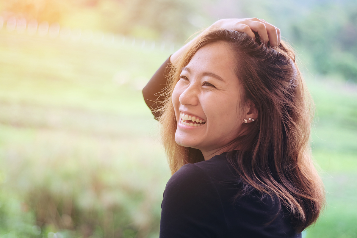 happy woman after building self esteem in drug rehab