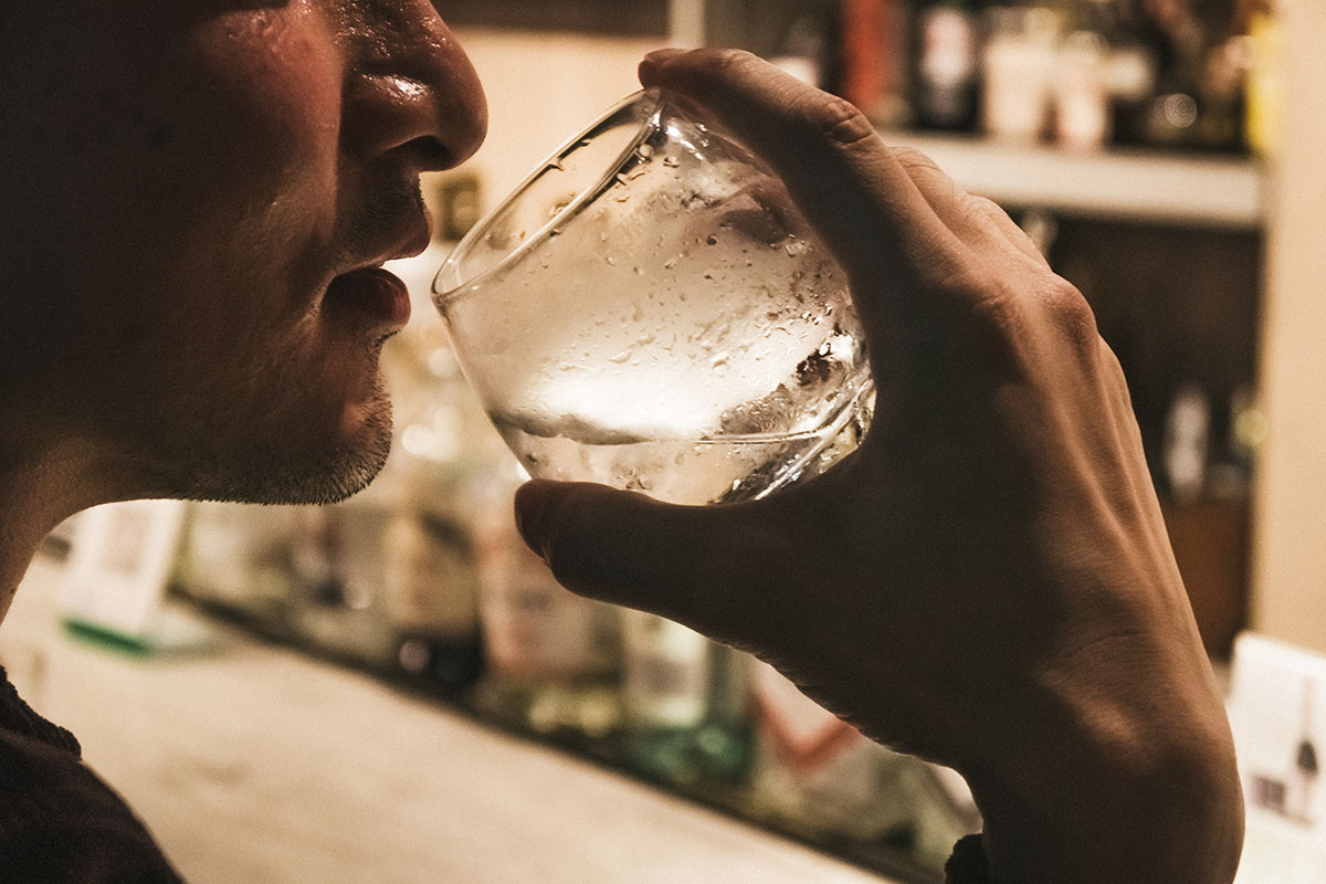 man struggling with alcohol and depression taking a drink