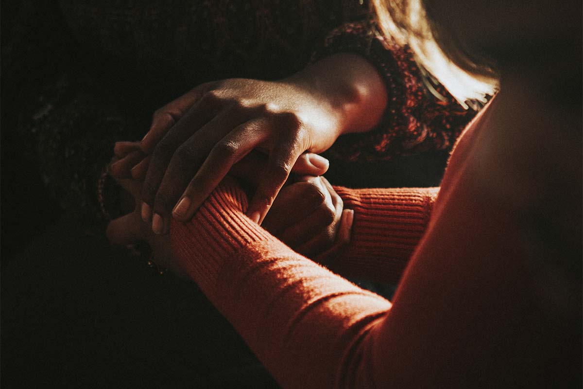 friends holding hands during aftercare planning