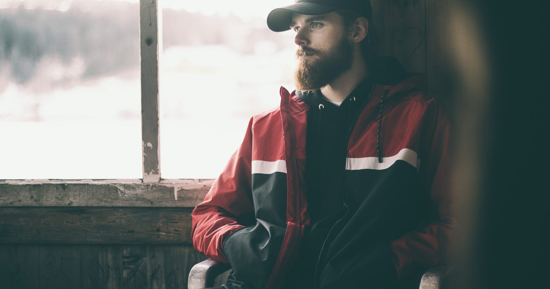 man leaning against window thinking about seasonal affective disorder