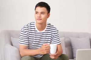 a man holding a mug at a polysubstance addiction treatment center