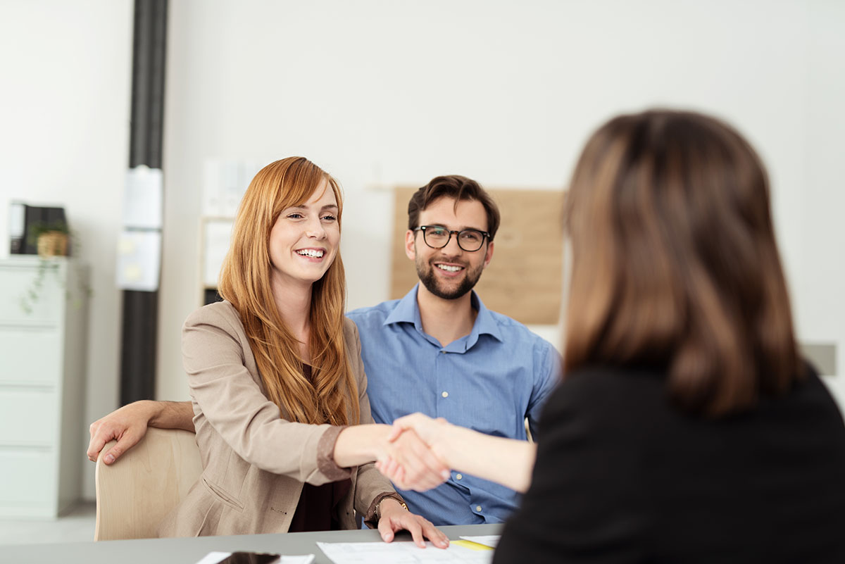 better addiction care, couple smiling shaking hands with therapist