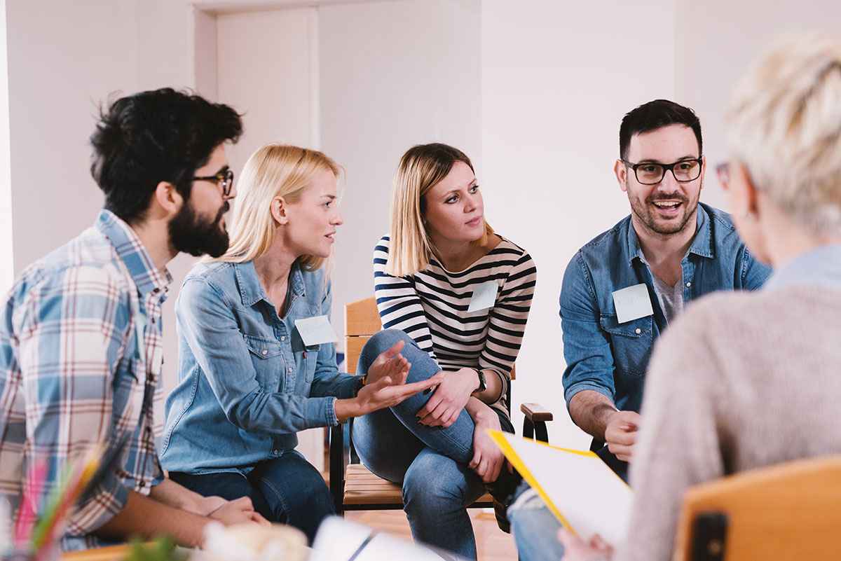 drug addiction treatment, group of people in therapy talking