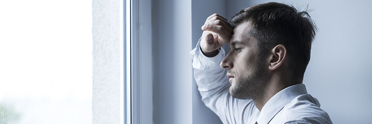 speed drug effects, man resting head on hand looks out window