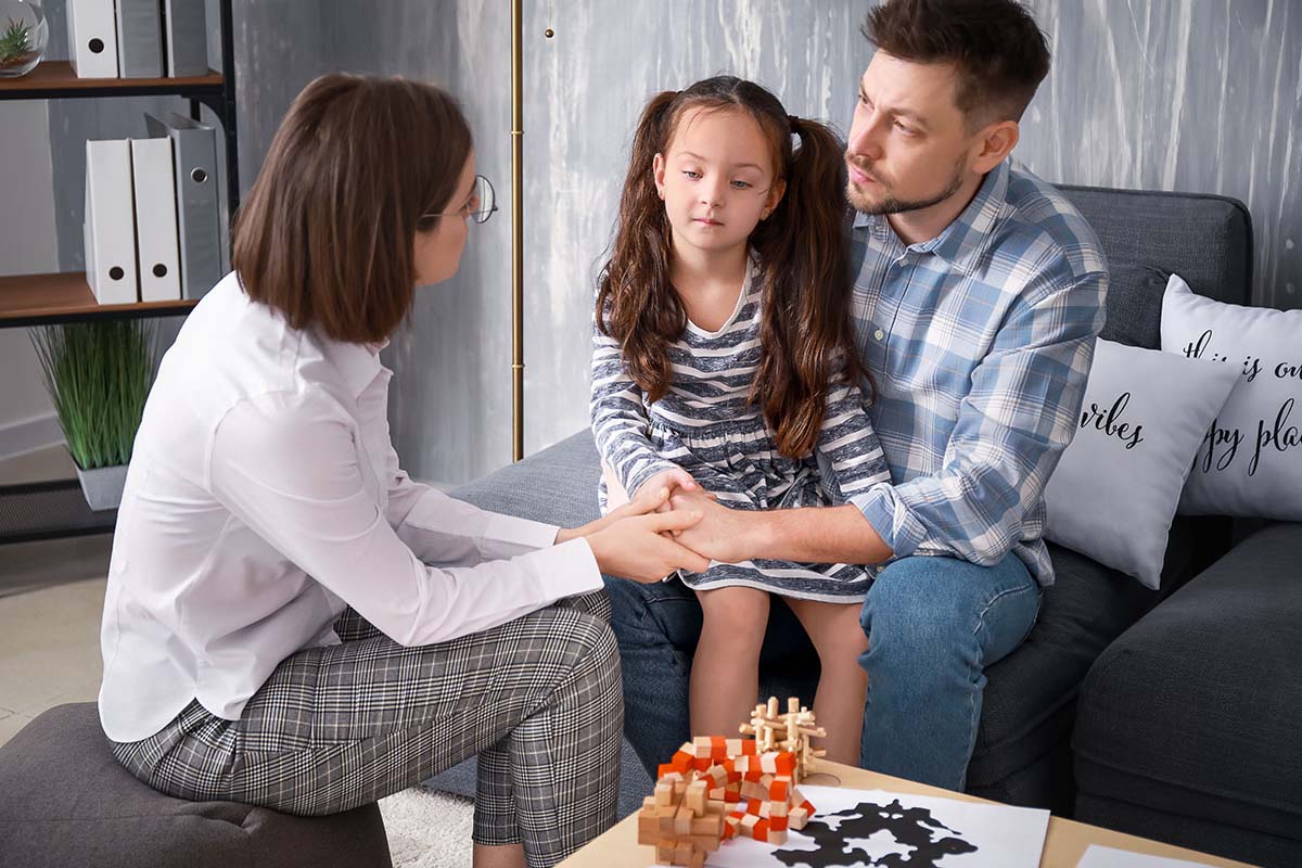 mom and child talking with dad in addiction recovery