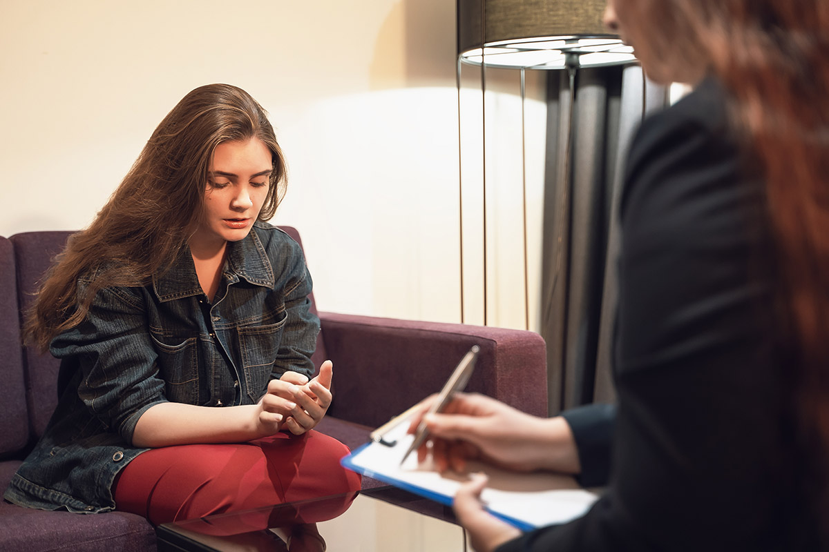 woman sitting in therapy for heroin addiction treatment