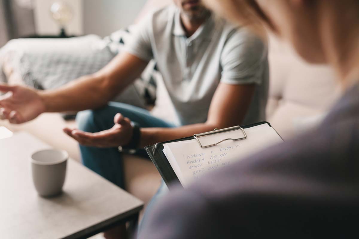 man speaking to therapist