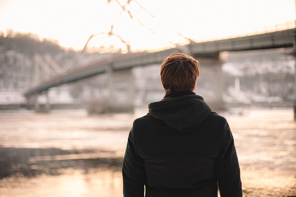 individual walking through a city struggling with alcohol and depression