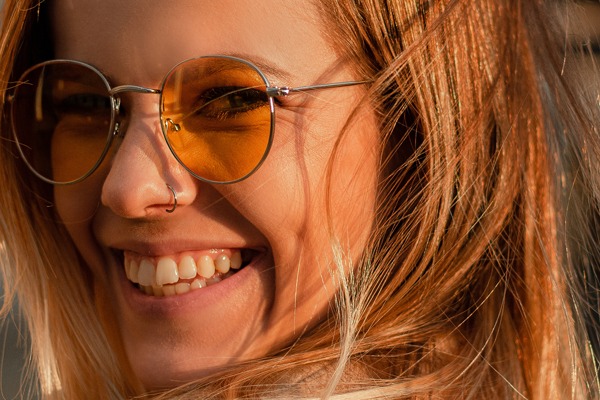 happy female smiling after learning how to manage your stress