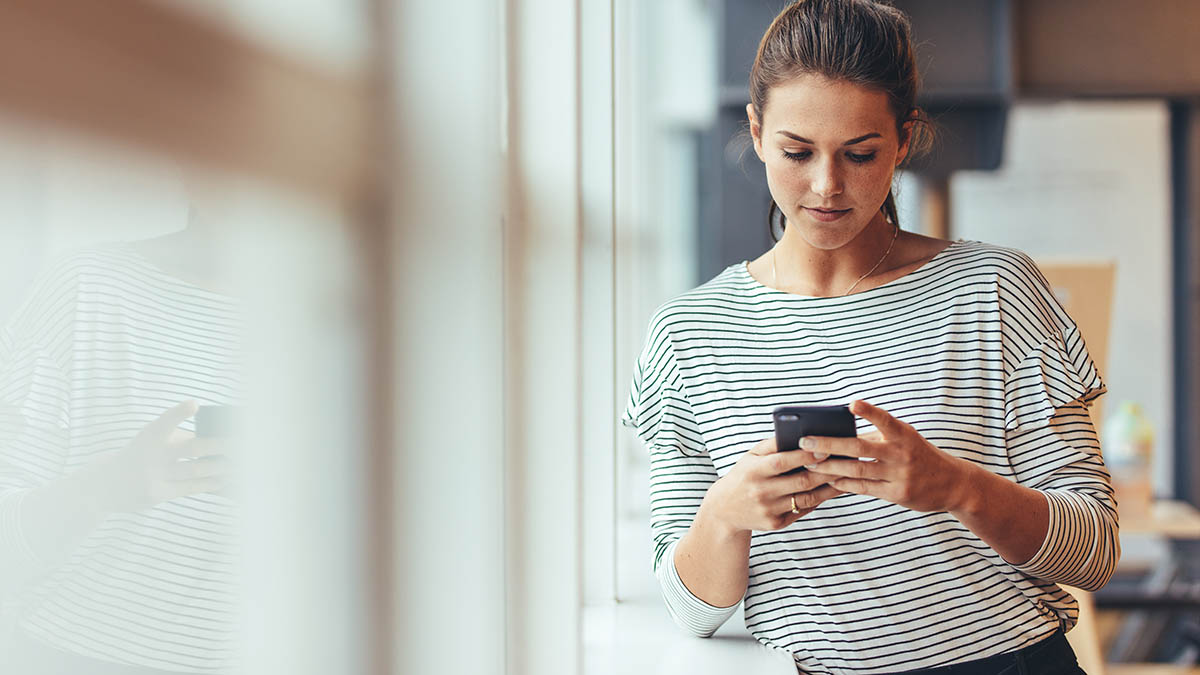 young woman on phone learning about the connection between addiction and social media