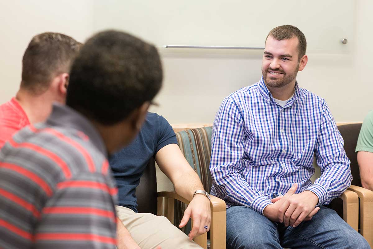 four men in residential group therapy