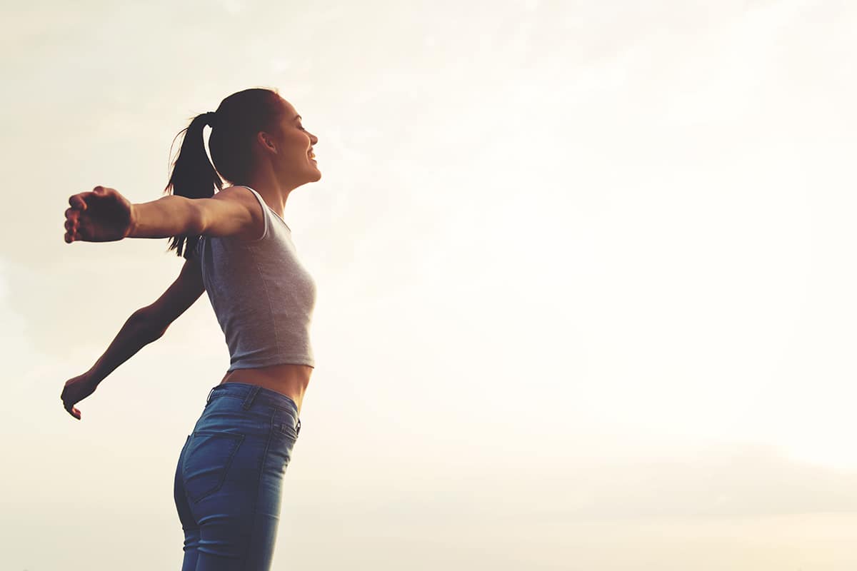 woman practicing yoga after learning what is national recovery month