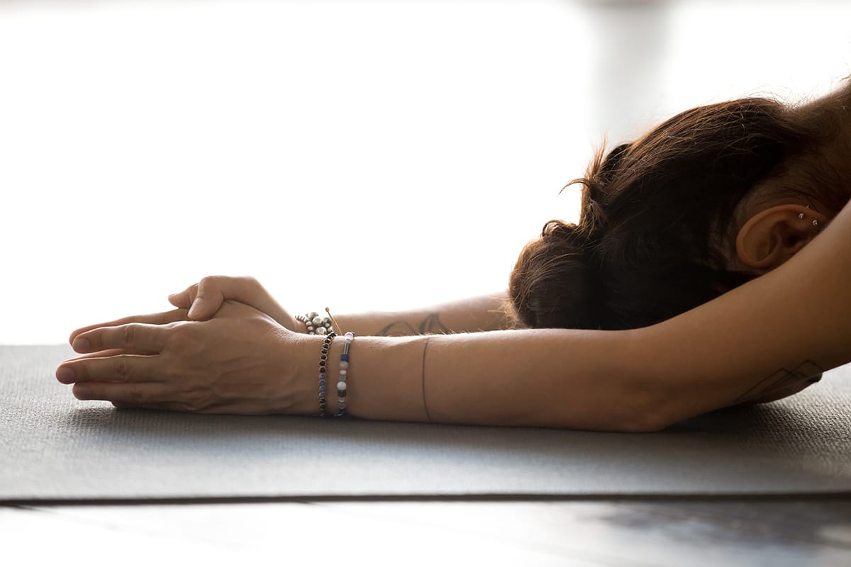 woman doing yoga as relapse prevention